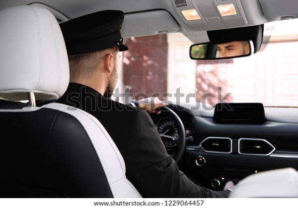Young driver in\
luxury car. Chauffeur\
service
