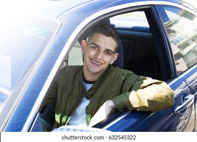 Young Driver Smiling In The Car