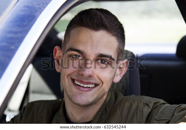 young driver smiling in the\
car