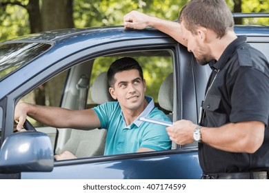 Young Driver Is Talking With Experienced Policeman