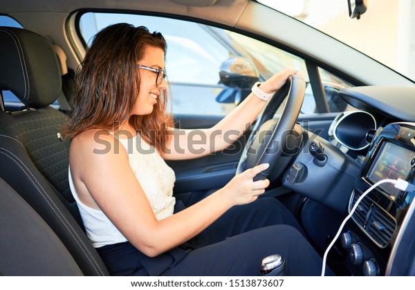 Young driver woman driving\
car