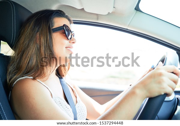 Young driver woman driving\
car