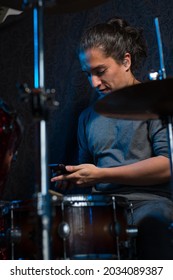 Young drummer playing his instrument. searching the track on his phone
musical composition
Latin American percussionist