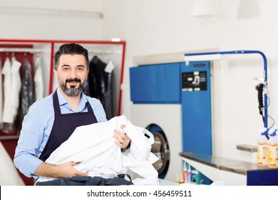 Young Dry Cleaner Posing At Camera.