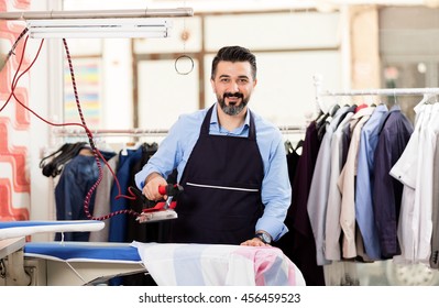 Young Dry Cleaner Posing At Camera.