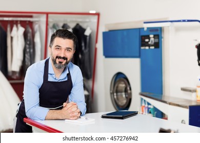 Young Dry Cleaner Posing At Camera.