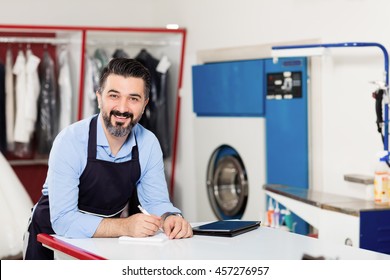 Young Dry Cleaner Posing At Camera.