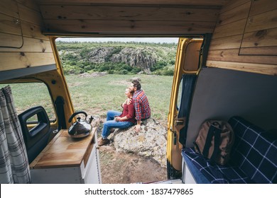 Young Eastern European Couple Travelling By Camper Van Though The Countryside. Self Built Off-grid Motorhome Camping In The Wild Nature.