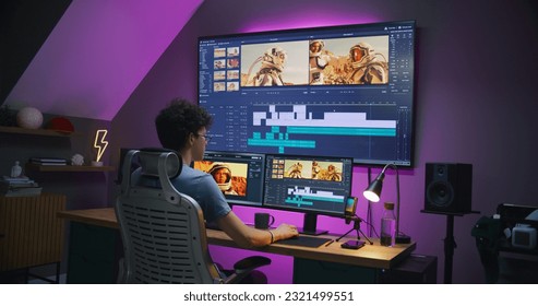 Young editor, video maker edits movie with astronauts, works at home office. Film footage and program interface with tools and sound tracks on computer and big digital screen. Post production concept. - Shutterstock ID 2321499551