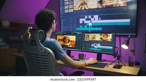 Young editor works at home office, edits sound tracks for video or movie about space mission. Film footage and software interface with tools on PC and big digital screen. Concept of post production. - Shutterstock ID 2321499547