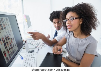 Young Editorial Team Working Together In Her Office