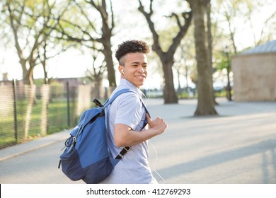 Young educated boy with packpack walk on college campus, photographed in New York City in April 2016.
