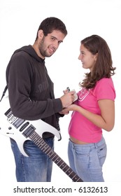 Young Electric Guitar Player Giving An Autograph To A Beautiful Young Girl