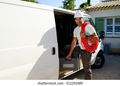 Young Electrician Artisan Taking Tools Out Of His Professional Truck Van