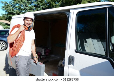 Young Electrician Artisan Taking Tools Out Of His Professional Truck Van