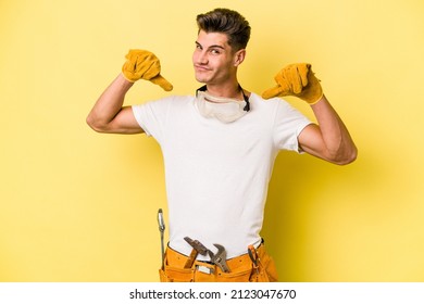 Young Electrician Caucasian Man Isolated On Yellow Background Feels Proud And Self Confident, Example To Follow.