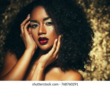 Young Elegant African American Woman With Afro Hair. Glamour Makeup. Golden Background. 