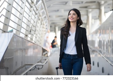 Young Elegant Business Woman With Hand Luggage Walking Along Sidewalk Outdoors In Urban City,business Trip,travel.