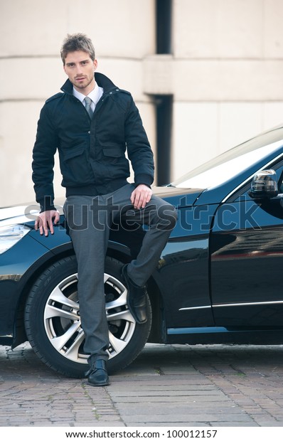 Young elegant man\
portrait with luxury car.