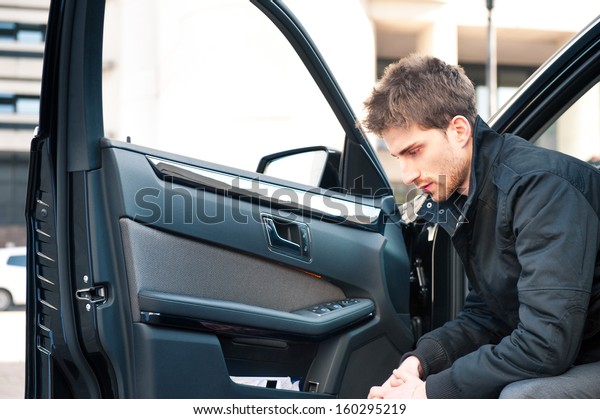 Young elegant man\
portrait with luxury car.\
