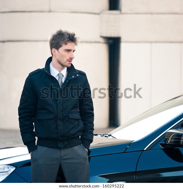 Young elegant man\
portrait with luxury car.\
