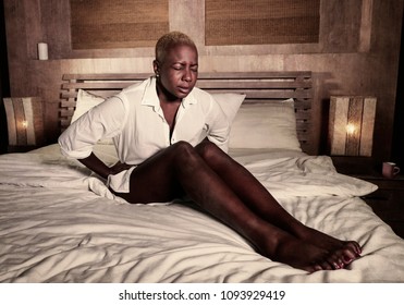 Young Elegant Sad And Depressed Black Afro American Woman Suffering Period Pain Or Stomach Ache And Abdominal Cramp Holding Her Tummy Feeling Sick And Unwell In Menstruation Cycle And Lifestyle