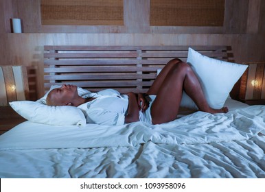 Young Elegant Sad And Depressed Black Afro American Woman Suffering Period Pain Or Stomach Ache And Abdominal Cramp Holding Her Tummy Feeling Sick And Unwell In Menstruation Cycle And Lifestyle