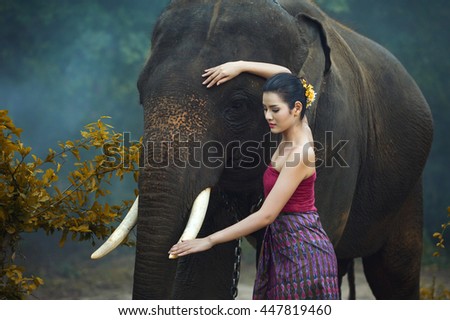Young elephant and woman Thai culture traditional ,vintage style