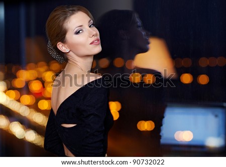 young ellegant woman standing on the ligths of the night city background Stock photo © 