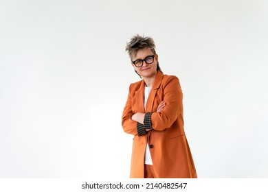 Young Emotional Non Binary Person Wearing Orange Color Suit Posing At Studio