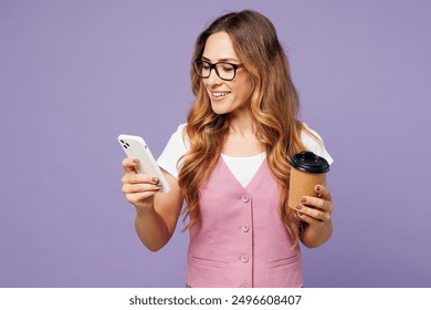 Young employee business woman corporate lawyer wears classic suit vest white t-shirt glasses work in office hold in hand use mobile cell phone drink coffee isolated on plain pastel purple background - Powered by Shutterstock