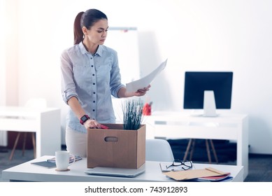 Young Employee Packing Her Stuff In Box While Leaving Work