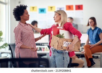 A young employee in a sad atmosphere in the office says goodbye to a colleague after she was fired. Employees, job, office - Powered by Shutterstock