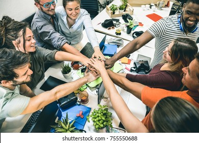 Young employee startup workers group stacking hands at urban studio during entrepreneurship brainstorming project - Business concept of human resources on working time - Start up internship at office