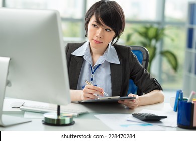 Young employee working at her pc