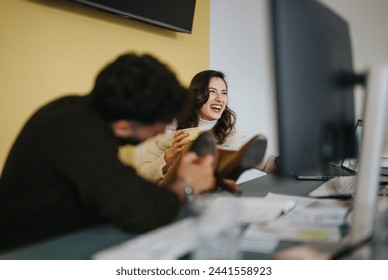 Young employees have fun at work. A male draws on the outsole of his female colleague's shoe. - Powered by Shutterstock