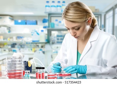 Young energetic female tech or scientist works in research facility. Shallow DOF, focus on the face.