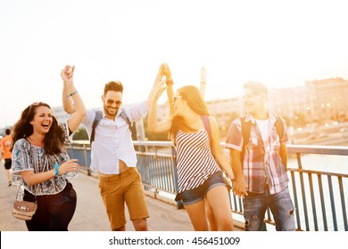 Young Energetic Group Of People Having Fun In City