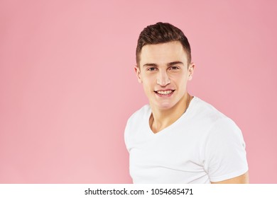 young energetic man on a pink background                               