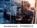 young it engeneer business man with thin modern aluminium laptop in network server room