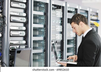 Young It  Engeneer Business Man With Thin Modern Aluminium Laptop In Network Server Room