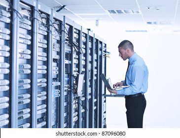 Young Engeneer Business Man With Thin Modern Aluminium Laptop In Network Server Room