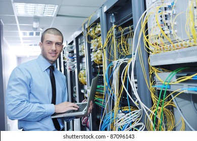 Young Engeneer Business Man With Thin Modern Aluminium Laptop In Network Server Room