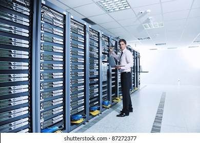 Young Engeneer Business Man With Thin Modern Aluminium Laptop In Network Server Room