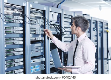 Young Engeneer Business Man With Thin Modern Aluminium Laptop In Network Server Room