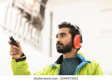 young engineer with beard checking with a flashlight