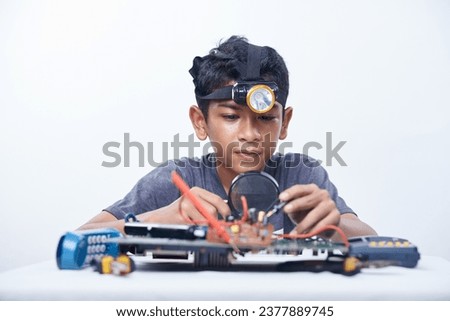Young engineer boy studying electronic component. Robotics, Hardware and software engineering for kids Inventions and creativity