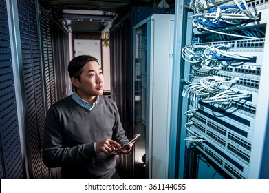 Young engineer businessman in server room