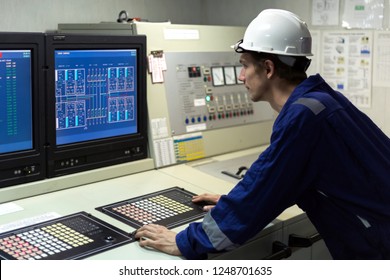 Young engineer in a cargo control room of a oil tanker.