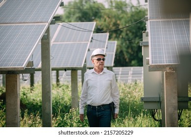 Young engineer checking with a tablet the sun's operation and cleanliness on the field of photovoltaic solar panels at sunset. Concept: renewable energy, technology, electricity,  - Shutterstock ID 2157205229
